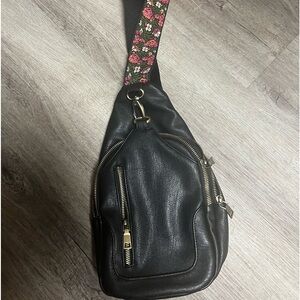 Black leather sling/cross body bag with floral strap design